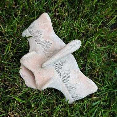 Cast caudal vertebra bone carved with a design contributed by Wichita and Affiliated Tribes