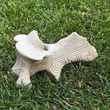 Cast cervical vertebra bone with carved spiral motif