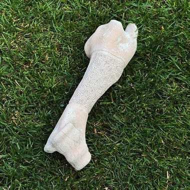 Cast humerus bone with carved circular motif band
